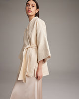 Model wearing a beige Samurai Jacket with wide sleeves and a belt