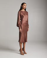 Model wearing a Bias Midi Skirt in Cupro Rayon, standing in profile