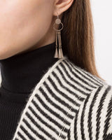 Model wearing chandelier earrings with a striped sweater
