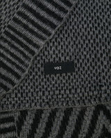 Close-up of Chevron Scarf showing texture and 'voz' label