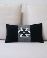 Handwoven black and ivory lumbar pillow featuring a ceremonial Condor symbol
