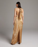 Back view of gold tie dye convertible dress with halter neck and open back