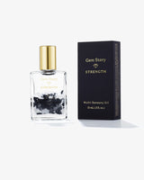Gem Story Strength Multi-Sensory Oil with black crystals in a glass bottle and box