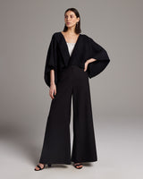 Model wearing a black hand-loomed Jungle Bolero with wide trousers