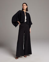 Model wearing a black Jungle Bolero with wide trousers