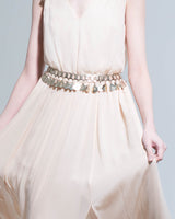 Model wearing a handmade silver alloy disc jewelry belt with intricate patterns