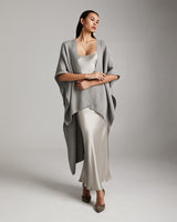 Model wearing a grey solid alpaca duster over a satin dress