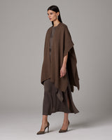 Model wearing a brown alpaca duster over a brown dress and heels.