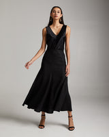Model wearing a black Linen Spiral Skirt with a fitted top