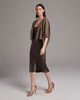 Model wearing a textured cotton bolero over a brown dress