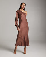Model wearing a brown bare shoulder dress with a flowing silhouette