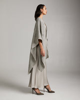 Model wearing a grey Copihue Duster in Baby Alpaca, styled with a long dress and heels.