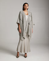 Model wearing a grey Copihue Duster in Baby Alpaca over a light dress