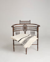Wide Diagonal Alpaca Blanket draped over a wooden chair