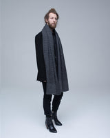 Model wearing a gray and black chevron scarf