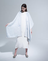 Model wearing a light blue Copihue Duster over a white dress