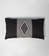 Top view of a black lumbar pillow with a diamond pattern in the center