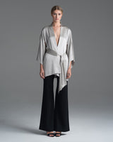 Model wearing a silver silk kimono with matching belt and black pants