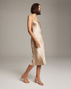 Model wearing a VOZ MIDI SLIP DRESS in a neutral tone, showcasing its elegant design.