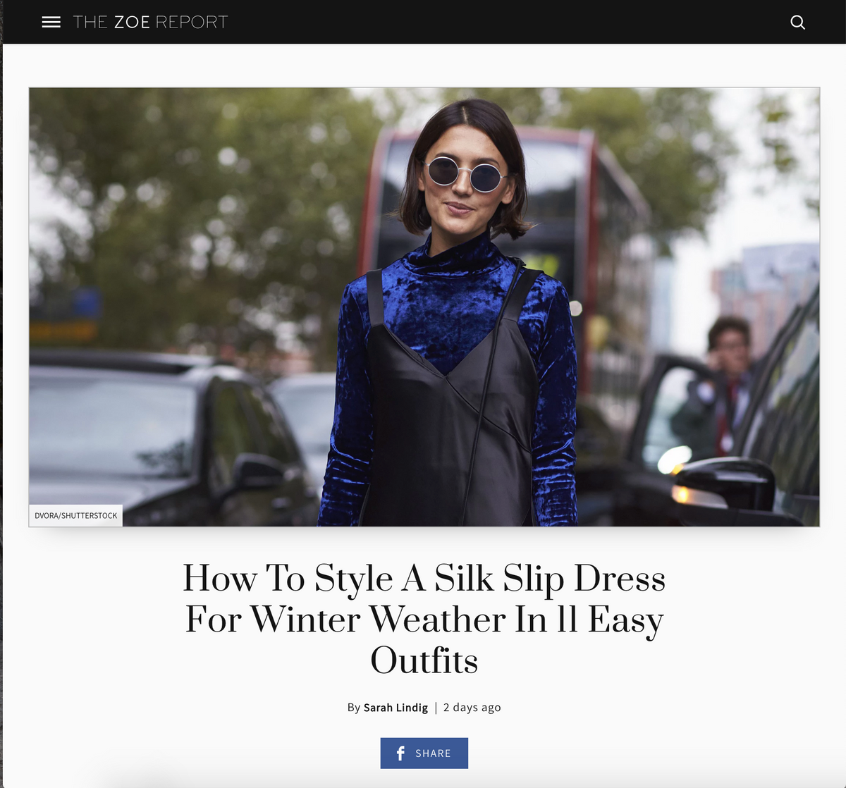 A woman wearing a blue velvet top over a black slip dress, styled for winter fashion.