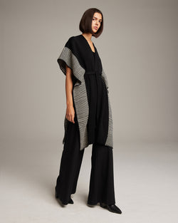 Model wearing Striped Edge Caftan in Merino, featuring a striped edge design.