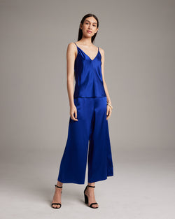 Model wearing a blue silk culotte outfit with a matching top