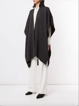 Model wearing a solid merino duster in charcoal color, styled with white pants and a blouse.