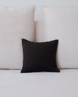 Brown and ivory Estrella square pillow on a light sofa