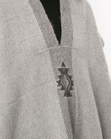 Light gray poncho with Estrella symbol design