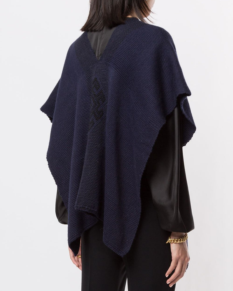 Back view of Manta Estrella poncho in navy, showcasing texture and design.