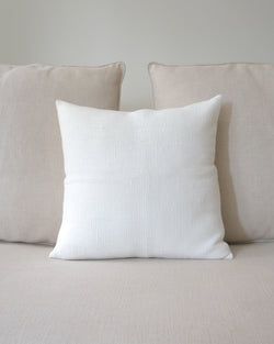 Solid Cotton Euro Pillow in Ivory on a beige couch