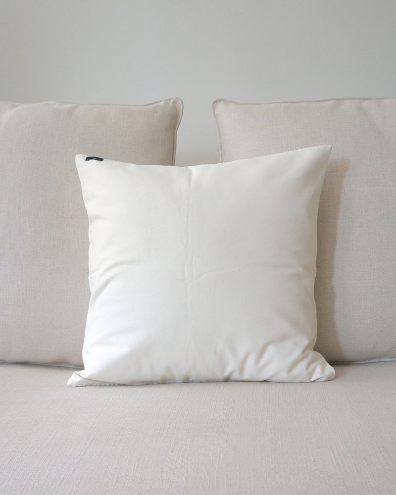 Ivory Solid Cotton Euro Pillow on a sofa