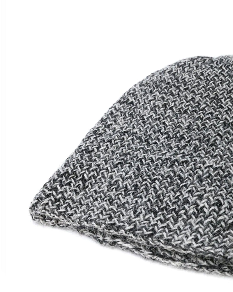 Close-up of a grey and black two-tone knit beanie showing texture