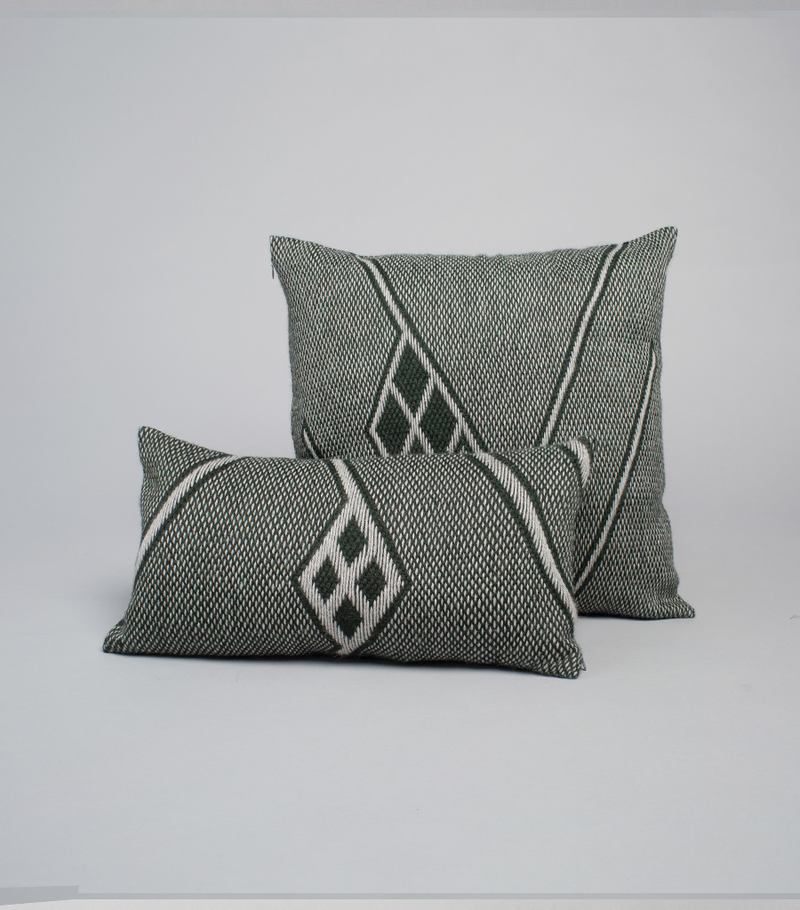 Two Che Lumbar Pillows in Forest Green with geometric patterns